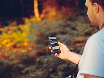 Man with phone struggling to get a signal